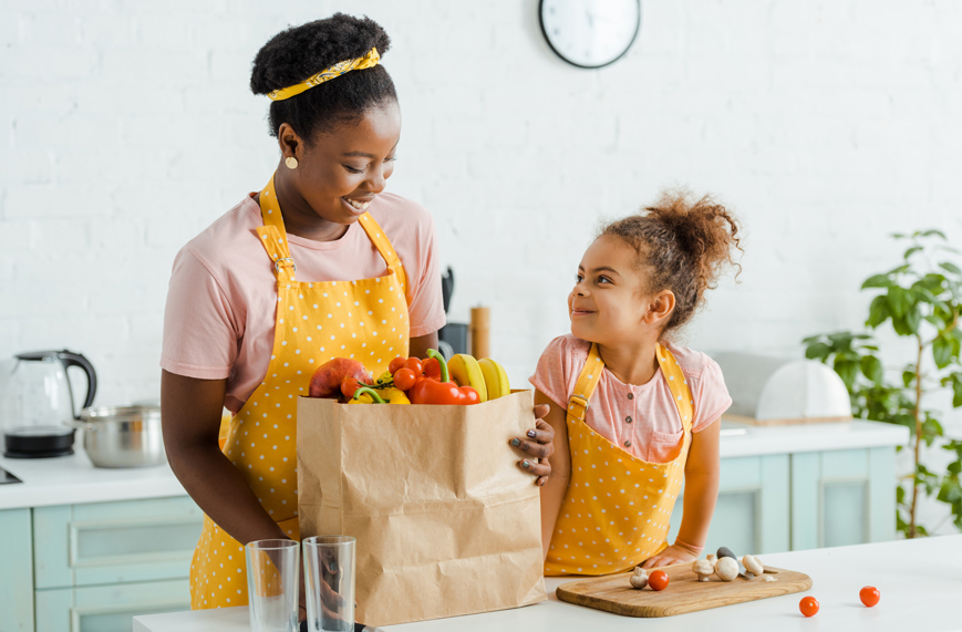 Mother and daughter with grocery bag